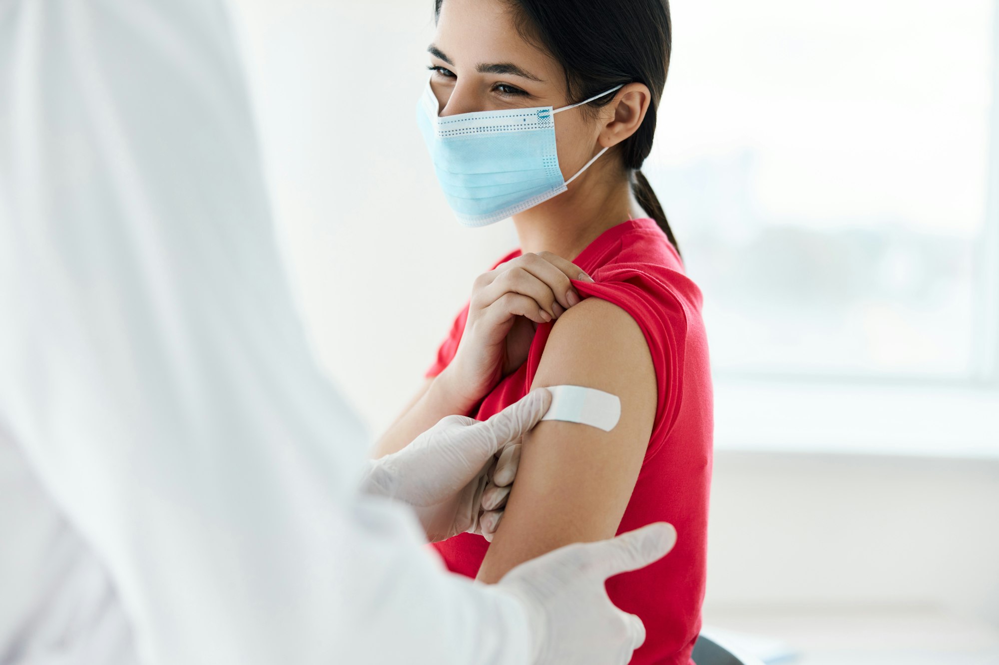 woman wearing medical mask patient injection coronavirus